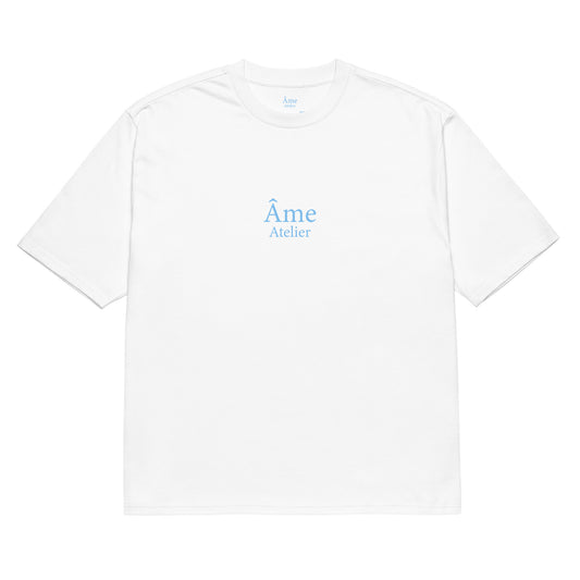 Front view of Âme Atelier oversized t-shirt in white with frozen blue details