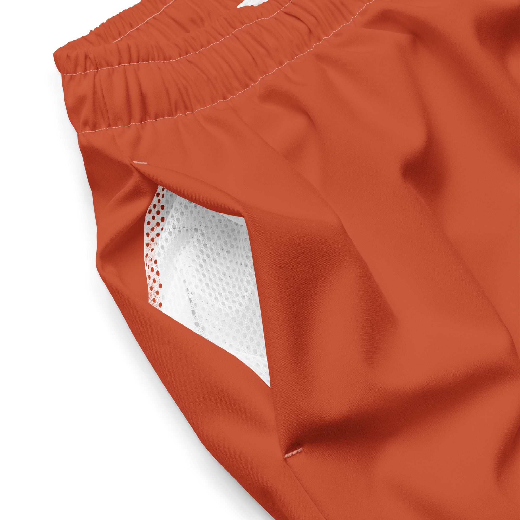 Close up of Âme Atelier swimming shorts in terracotta