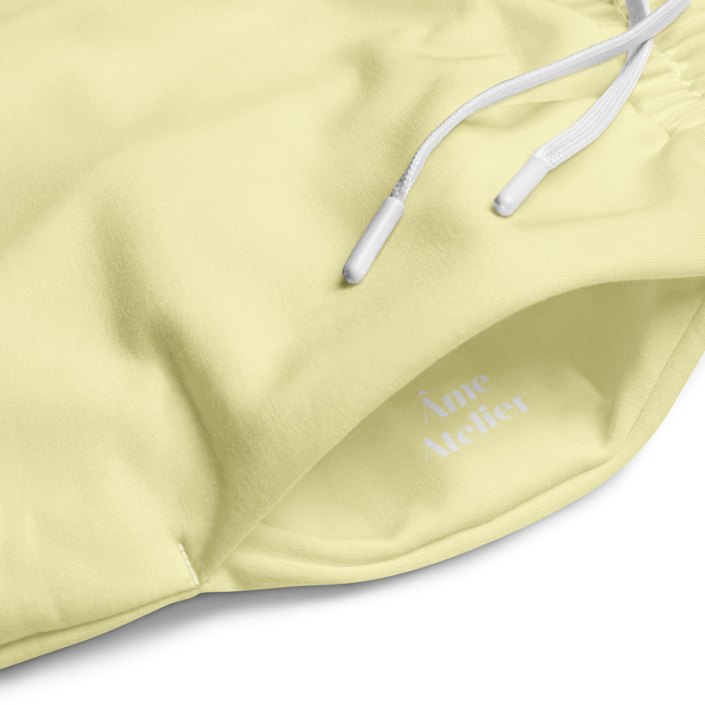 Details of Le Cosy recycled polyester trousers in soft yellow