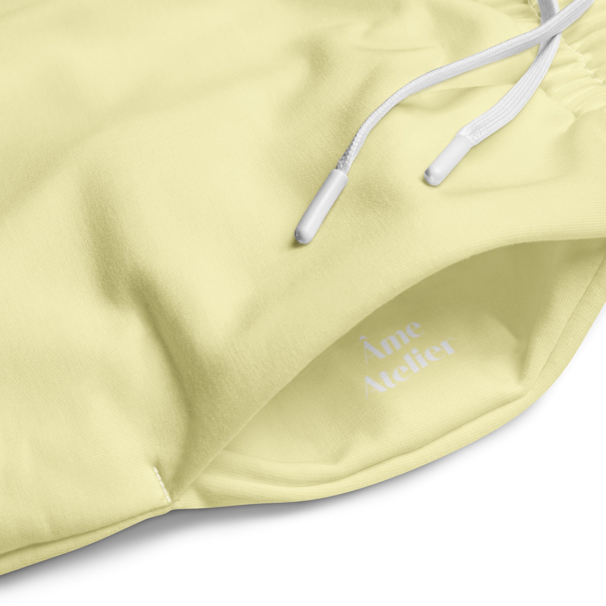 Details of Le Cosy recycled polyester trousers in soft yellow