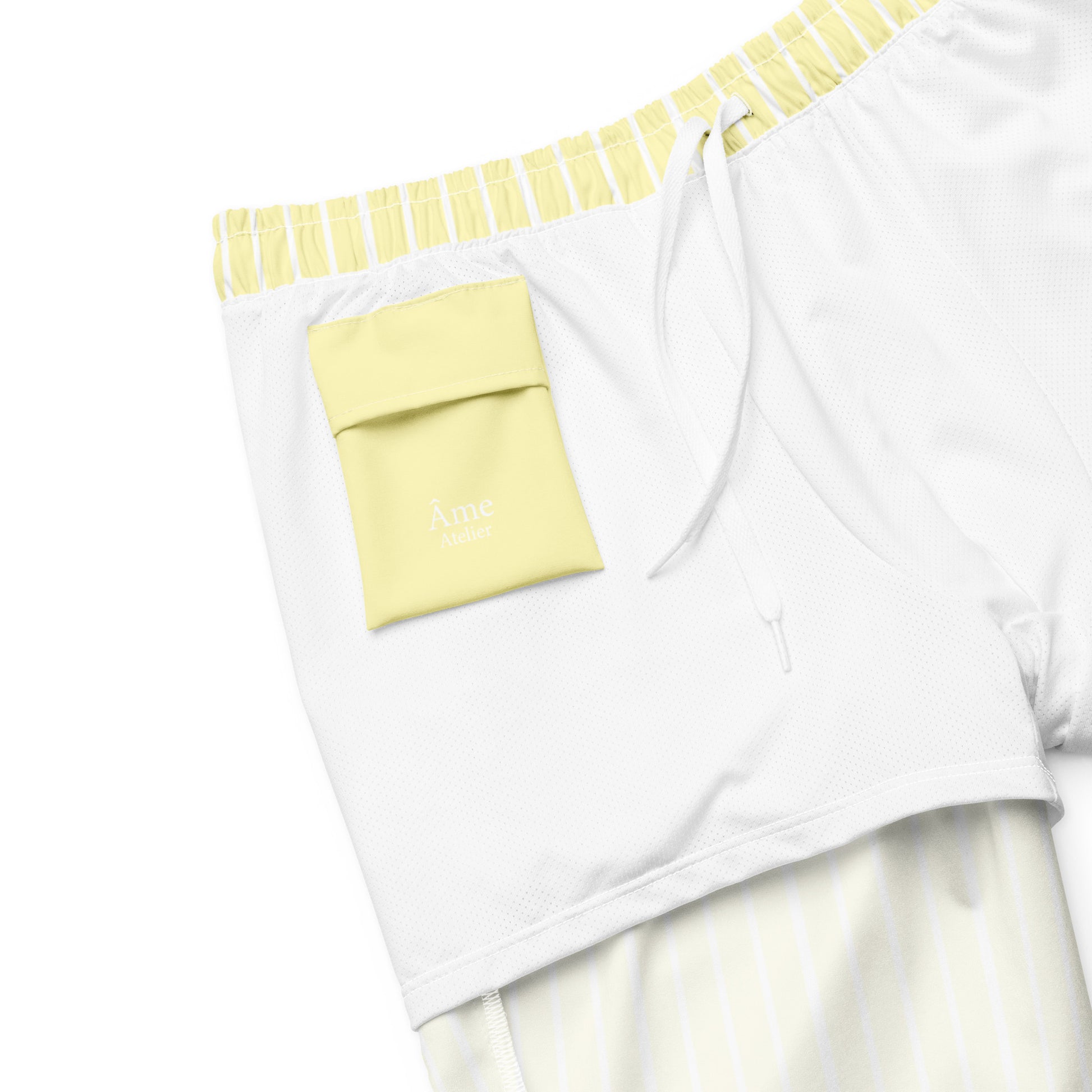 Inside pocket of Le Rayé striped swimming shorts in soft yellow