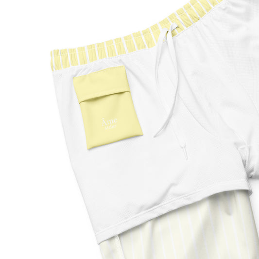 Inside pocket of Le Rayé striped swimming shorts in soft yellow