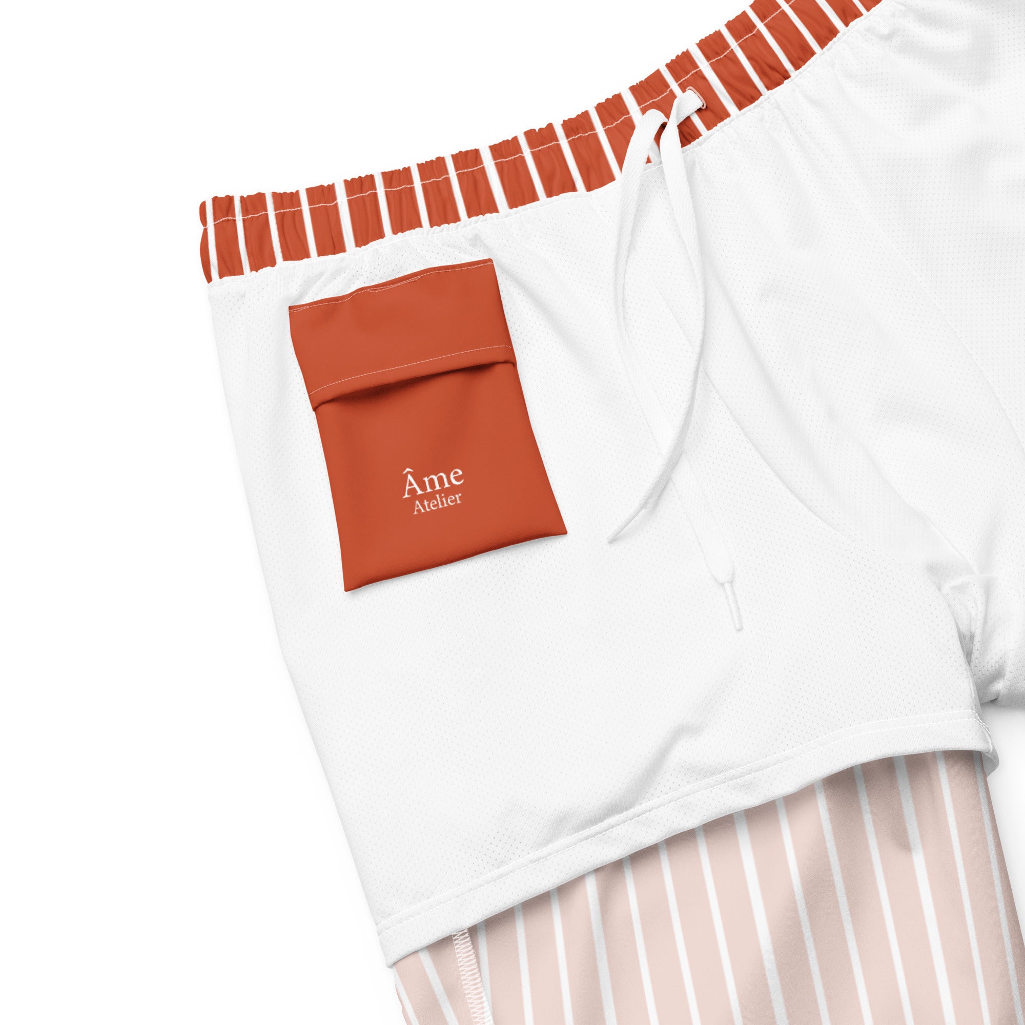Inside pocket of Le Rayé striped swimming shorts in terracotta