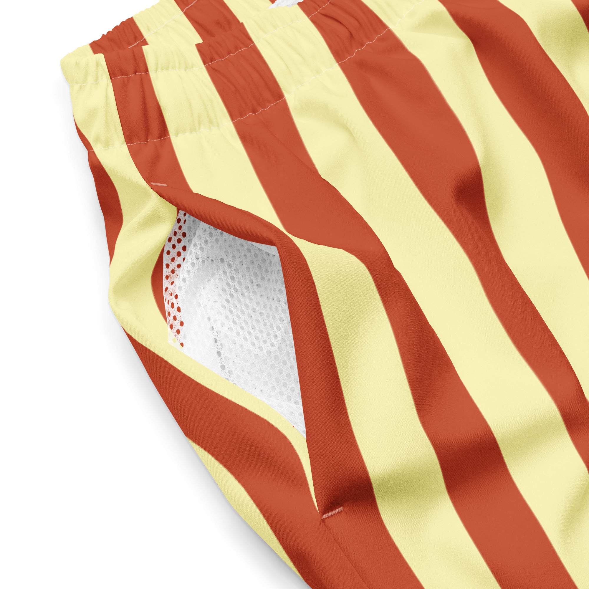 Close up of Le Vibrant striped swimming shorts in terracotta and soft yellow