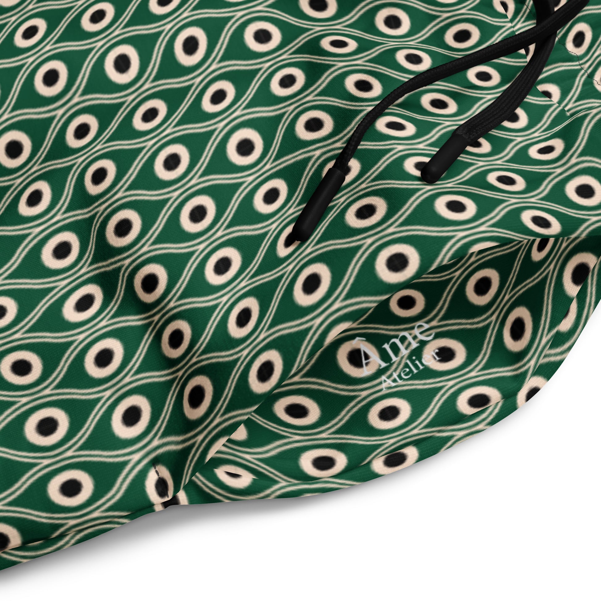 Close up of L'œil de paon pants in abyss green with peacock pattern