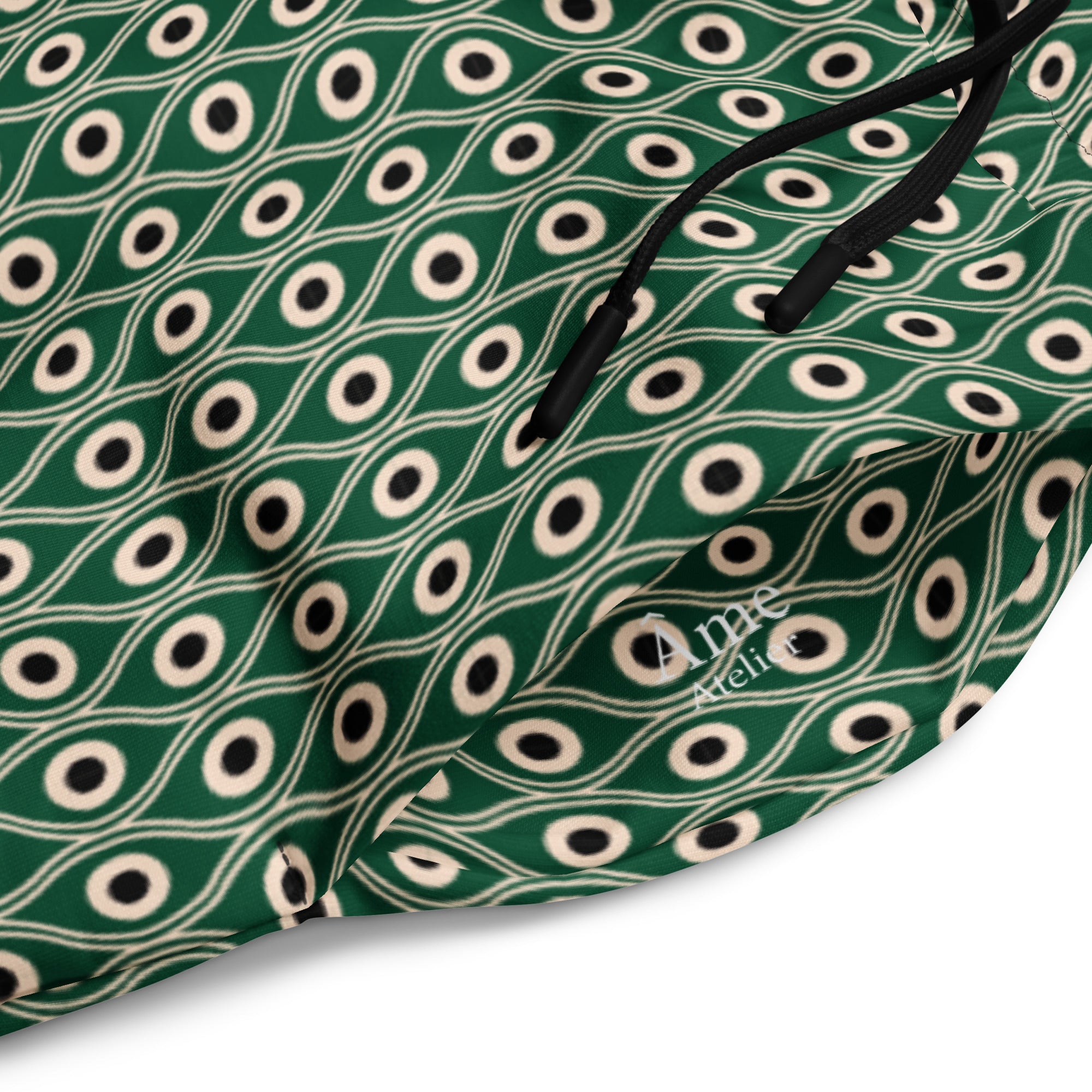 Close up of L'œil de paon pants in abyss green with peacock pattern