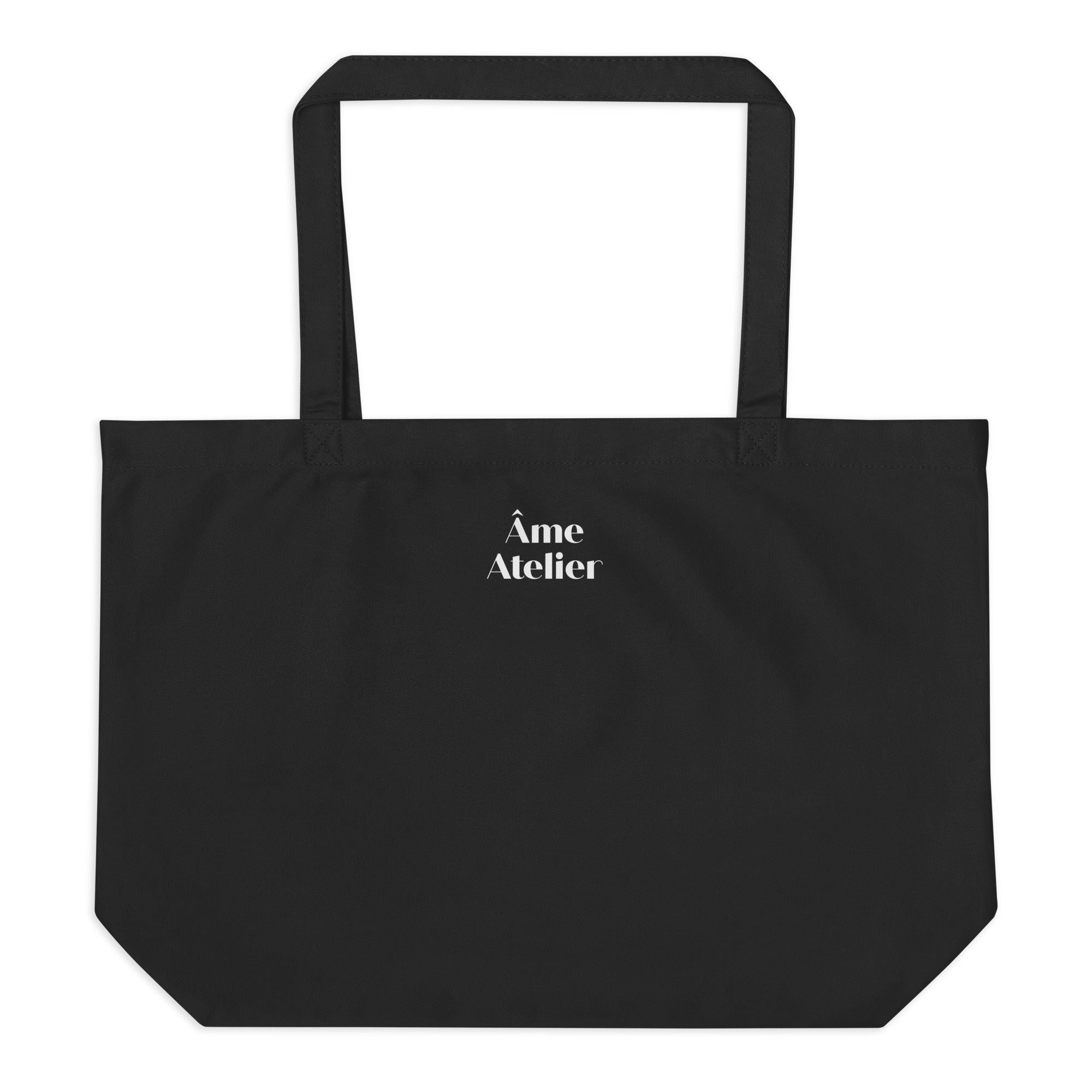 Back view of Nuit Éphémère organic cotton tote bag with a moon printed on the front and Âme Atelier logo on the back